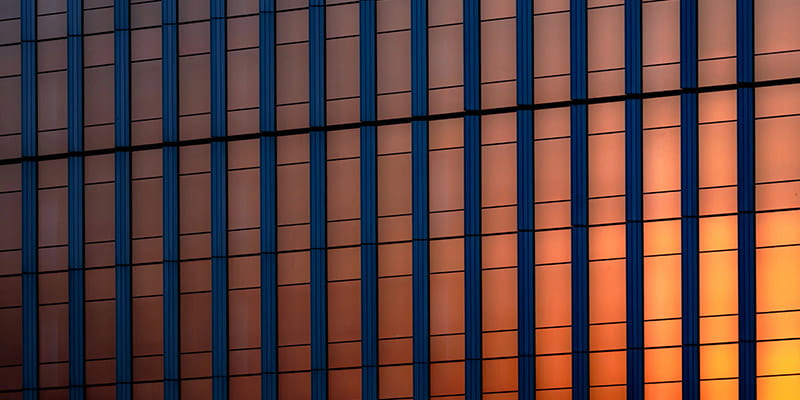 A silhouette of a building against a vibrant sunset sky used in Australian M&A Deal Report 2026 Chapter- What can we expect from Public M&A in 2026.