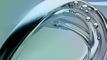  A reflective metal sphere floating in clear water, creating ripples around it.