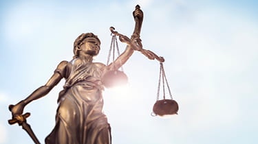 Lady justice statue against a sky background