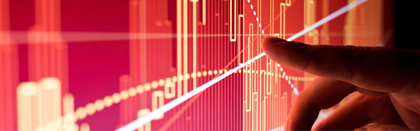 Finger pointing to graph on electronic screen
