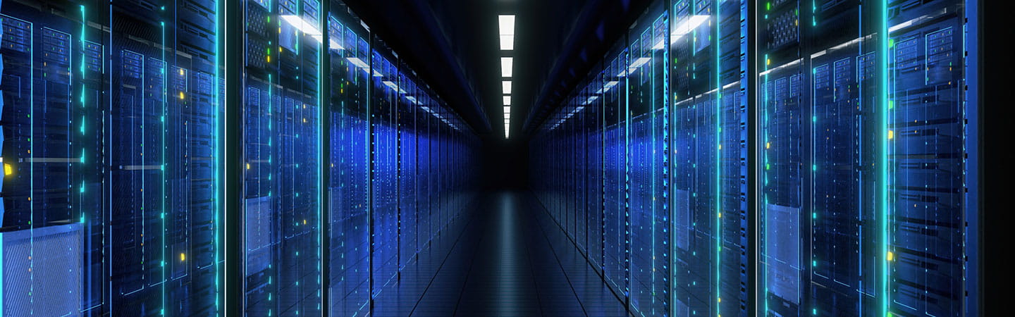 A long hallway lined with rows of servers, showcasing a modern data center environment.