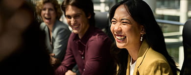 A group of professionals having a joyful conversation.