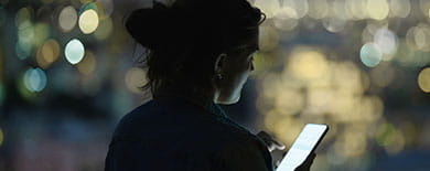 Woman looking at mobile at night
