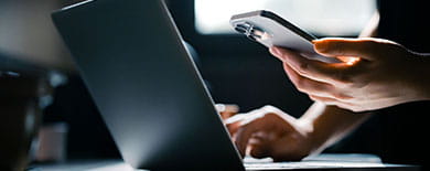 Man working on laptop and mobile