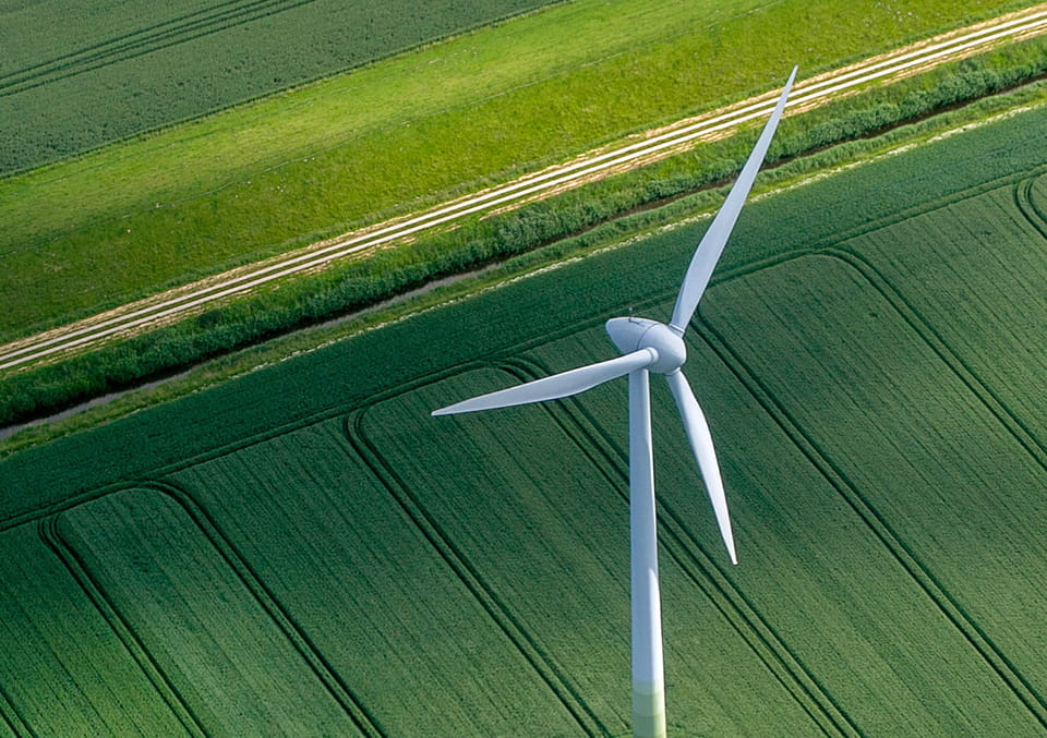 Windmill overlooking fields in Caught in the Crosswinds article banner
