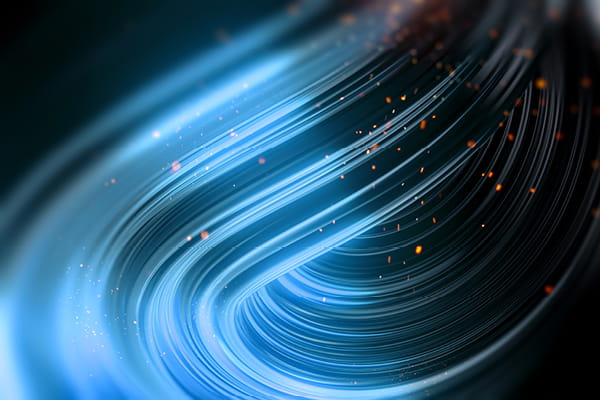 Curved blue light streaks with glowing orange sparks on dark background used in our Ahead of the Deal series