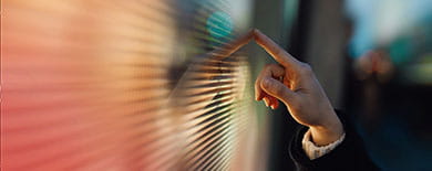 Finger pointing at screen